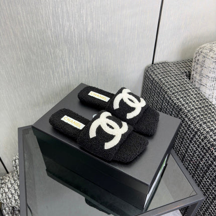 CHANEL 26S SLIDE SANDALS IN BLACK SHEARLING AND WHITE CC LOGO SQUARE TOE