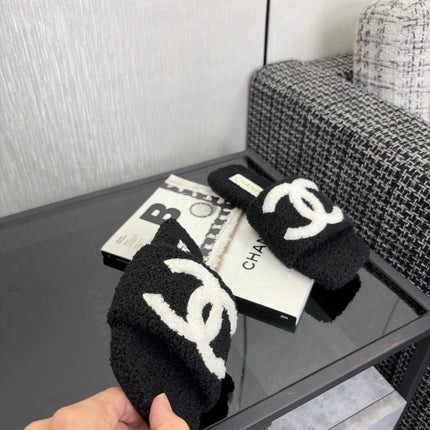 CHANEL 26S SLIDE SANDALS IN BLACK SHEARLING AND WHITE CC LOGO SQUARE TOE