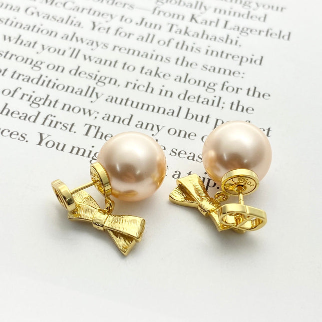 CD 26S PEARL BOW DROP EARRINGS IN GOLD TONE METAL 644484